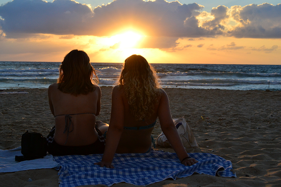 Two girls watchinig sunset at Haifa Hof Hacarmel Beach